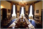 A White House usher prepares the Blue Room for a luncheon for the European Commission May 2, 2002. 