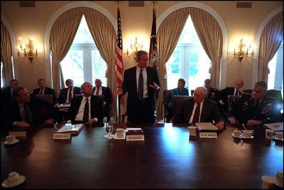 President George W. Bush meets with Vice President Richard Cheney, Secretary of Defense Donald Rumsfeld, Secretary of State Colin Powell, Chairman of the Joint Chiefs of Staff Richard Myers and the other members of the National Security Council in the Cabinet Room following the terrorist attacks, Sept. 12, 2001.