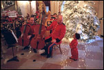 A member of the Marine Band greets a young fan in the Cross Hall during the 2001 holiday season at the White House.