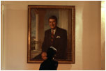 In between meetings, National Security Adviser Condoleezza Rice studies a portrait of President Ronald Reagan in the Cross Hall on Feb. 13, 2002. 
