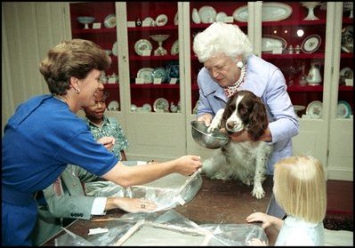 With a curious look, first pet Millie Bush has her paw print made for a greeting card in the China Room on July 2, 1991. Millie's owners were President George H.W. Bush and Barbara Bush. Millie's offspring, Spot, now lives in the White House with President George W. Bush and Laura Bush.