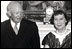 President Dwight Eisenhower and Mamie Eisenhower receive a donation of antique furniture for the Diplomatic Reception Room of the White House on June 29, 1960. The Federal style furniture includes a pale gold silk sofa and matching chairs. Joining the Eiswenhowers are Michael Greer of the National Society of Interior Designers, Inc. and designer Dora Brahms. 