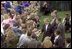 President George W. Bush greets an enthusiastic crowd of visitors on the South Lawn.