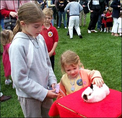 Four-year-old Lexi Rhem pets a magician's bunny while her sister, 10-year-old Monica Ollander, looks on. They were among thousands of children who took part in a 125-year-old American tradition April 21 - the White House Easter Egg Roll. 