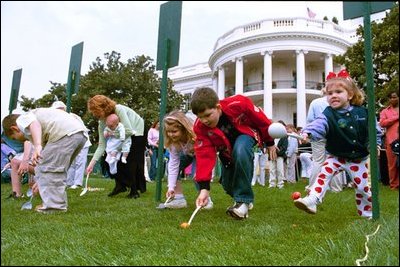 Carrying on a tradition started by President Rutherford B. Hayes in 1878, children roll hard-boiled eggs across the South Lawn during the annual White House Easter Egg Roll Monday, April 21, 2003. In honor of America's service personnel, the festivities this year were open to U.S. military families. 