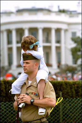 Uniforms, frilly dresses and power nappers and dot the landscape of the South Lawn during the White House Easter Egg Roll Monday, April 21, 2003. About 12,000 military families came out to spend the day racing with Easter eggs, play games, listen to children's stories and take the occasional nap on the South Lawn. 