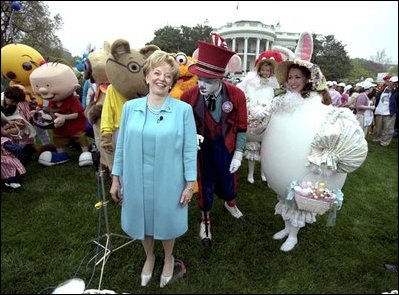 Accompanied by all sorts of story book characters, Lynne Cheney the host of the 2003 White House Easter Egg Roll, addresses the media on the South Lawn Monday, April 21, 2003. "But most of all, we are proud of all of you, the men and women who serve our country, who keep our country free," said Mrs. Cheney in her opening remarks welcoming U.S. military families to the event.