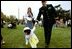 A tiny Easter egg toddler leads the charge at the White House Easter Egg Roll Monday, April 21, 2003. About 12,000 U.S. military families came to the South Lawn to race with Easter Eggs, play games, and listen to children's stories. 