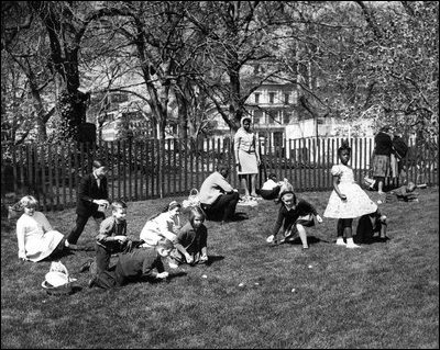 Children play with eggs on the South Lawn of the White House in 1963. The Eisenhower Executive Office Building is pictured in the background. 