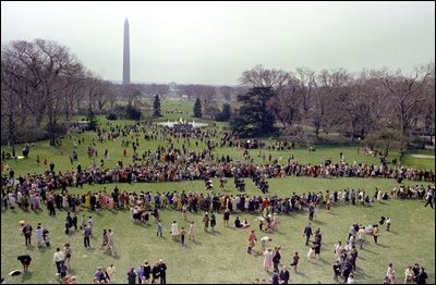 The Marine Band parades across the South Lawn as crowds gather to watch at the 1967 annual Easter Egg Roll. It was first in 1889 when President Benjamin Harrison requested the "President's Own" Marine Band to play. 