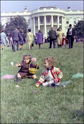 Two little girls play with real colored Easter eggs at the 1967 White House Easter Egg Roll on the South Lawn. While plastic eggs were used in 1975, the use of real eggs returned soon after in 1977.