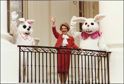 Former First Lady Nancy Reagan and two Easter bunnies wave from the south portico of the White House. In 1981, Nancy Reagan introduced the egg hunt and autographed souvenir wooden eggs to the White House Easter Egg Roll. 