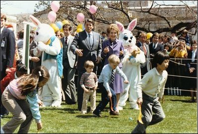President Reagan and First Lady Nancy Reagan watch as children roll eggs at the 1982 White House Easter Egg Roll. 