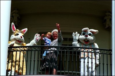 Former First Lady Barbara Bush and two Easter bunnies wave from the balcony of The White House at the 1989 Easter Egg Roll. 
