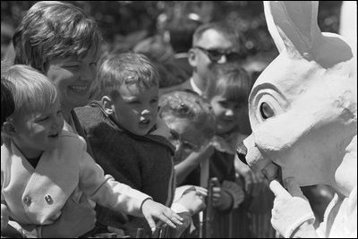 Mother and children smile as they are entertained by The Easter Bunny at the 1969 White House Easter Egg Roll.