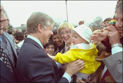 President Carter smiles as he reaches out to a young fan at the 1980 White House Easter Egg Roll.