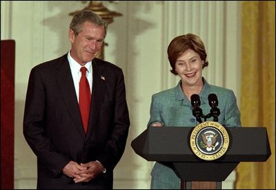 President and Mrs. Bush highlight the importance of early childhood education in an East Room event April 3, 2002. Following their remarks, PBS KIDS characters from Sesame Street, Mr. Rogers' Neighborhood and Between the Lions entertained the audience.