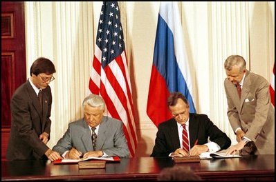 Side by side, President George H.W. Bush and Russian President Yeltsin sign seven trade treaties in the East Room June 17, 1992. The treaties removed barriers to trade that had evolved during the Cold War. The United States also granted Russia most-favored-nation status in trade relations for the first time in more than four decades. 