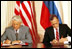 Side by side, President George H.W. Bush and Russian President Yeltsin sign seven trade treaties in the East Room June 17, 1992. The treaties removed barriers to trade that had evolved during the Cold War. The United States also granted Russia most-favored-nation status in trade relations for the first time in more than four decades. 