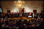 Joined by members of Congress and 15 American families in the East Room June 7, 2001, President George W. Bush signs the Tax Relief Act, which provides Americans with across-the-board tax cuts. 