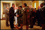 With a portrait of America's first General and first President hanging in the background, President George W. Bush and Defense Secretary Donald Rumsfeld congratulate military re-enlistees in an event held in the East Room May 23, 2001. Congress purchased the portrait of George Washington by Gilbert Stuart for the White House in 1800. 