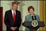 President and Mrs. Bush highlight the importance of early childhood education in an East Room event April 3, 2002. Following their remarks, PBS KIDS characters from Sesame Street, Mr. Rogers' Neighborhood and Between the Lions entertained the audience