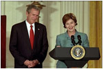 President and Mrs. Bush highlight the importance of early childhood education in an East Room event April 3, 2002. Following their remarks, PBS KIDS characters from Sesame Street, Mr. Rogers' Neighborhood and Between the Lions entertained the audience