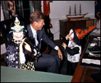 President John Kennedy meets with his halloween-clad children, Caroline and John, Jr., in the Oval Office. 