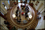President George W. Bush hosts a meeting with senior advisers in the newly-renovated Oval Office, which includes a specially-designed wool rug featuring the Presidential coat of arms Dec. 20, 2001. The color scheme of the first Oval Office, built in 1909 during the Taft Administration, was olive green.