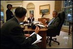Before his address to Congress and the nation following the attacks of September 11, President George W. Bush meets with speechwriter Michael Gerson, National Security Advisor Condoleezza Rice and Counselor Karen Hughes in the Oval Office Sept. 20, 2001. 