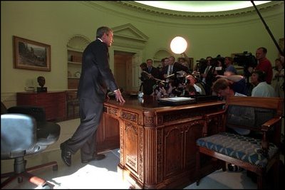 After talking with Governor George Pataki and Mayor Rudolph Giuliani in a televised telephone conversation, President Bush addresses reporters in the Oval Office September 13, 2001.