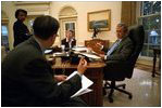 Before his address to Congress and the nation following the attacks of September 11, President George W. Bush meets with speechwriter Michael Gerson, National Security Advisor Condoleezza Rice and Counselor Karen Hughes in the Oval Office Sept. 20, 2001. 