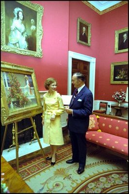 Rosalynn Carter admires a painting in the Red Room with White House Curator Clem Conger September 28, 1977.