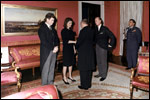 With her brother-in-law Edward Kennedy at her side, Jacqueline Kennedy greets guests in the Red Room following the funeral for her husband, President John Kennedy.