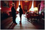 Vice President Dick Cheney and Dr. Condoleezza Rice speak in the Red Room before a press availability by the President of Pakistan Feb. 13, 2002. In contrast to the large East Room, the smaller Red Room has provided a place for quiet conversation over the years.