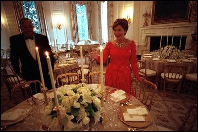 Laura Bush lights the candles for the administration's first state dinner, which welcomed Mexican President Vicente Fox and 136 guests Sept. 5, 2001. Before the 1902 renovation, the State Dining Room was 30 percent smaller and only able to accommodate 40 guests for dinner. 