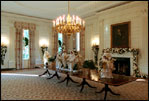 Decorated for the holidays, the State Dining Room showcases custom-made white and gold carolers, Dec. 5, 2001. 
