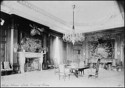 President Theodore Roosevelt's State Dining Room was baronial style and featured stuffed moose and elk heads on the walls. In contrast, the first cabinet dinner in this room on Dec. 18, 1902 featured pink roses and candles. 