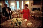Laura Bush lights the candles for the administration's first state dinner, which welcomed Mexican President Vicente Fox and 136 guests Sept. 5, 2001. Before the 1902 renovation, the State Dining Room was 30 percent smaller and only able to accommodate 40 guests for dinner. 