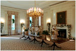 Decorated for the holidays, the State Dining Room showcases custom-made white and gold carolers, Dec. 5, 2001. 