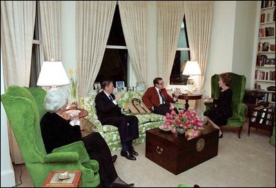Sitting in the first floor library of the Naval Observatory, then-Vice President George H. W. Bush, second on right, and his wife Barbara Bush, left, talk with then-President Ronald Reagan, second on left, and Nancy Reagan, right, Feb. 12, 1981.