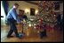 As a camera captures his every move, Barney follows behind Spot as they take a look at the bird ornaments on the White House Christmas Tree in the Blue Room, Monday Dec. 9, 2002.