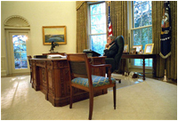 As President George W. Bush calls Australia to talk with Prime Minister John Howard, Spot finds her own place inside the Oval Office to pass the time Sept. 28, 2001.