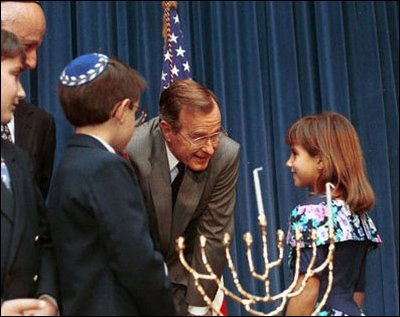 President George H.W. Bush speaks to children at a Menorah Lighting Ceremony. 