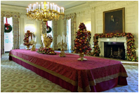 Cheerful garlands and bright sprays of greenery decorate the mantel and cascade from wall sconces in the State Dining Room. Ed and Cindy Hedlund and their son Thomas, of Hedlund Christmas Farm in Elma, Washington presented this year's 18-foot noble fir to President George W. Bush and wife Laura Bush. 