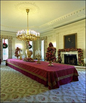 Cheerful garlands and bright sprays of greenery decorate the mantel and cascade from wall sconces in the State Dining Room. Ed and Cindy Hedlund and their son Thomas, of Hedlund Christmas Farm in Elma, Washington presented this year's 18-foot noble fir to President George W. Bush and wife Laura Bush. 
