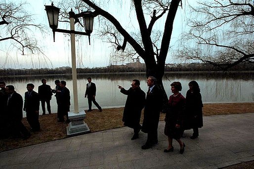 President Bush and Mrs. Bush walk with Chinese President Jiang Zemin at the Zhongnanhai leadership compound in Beijing, Friday, Feb. 22. "This is the 30th year -- 30th anniversary of President Nixon's first visit to China, the beginning of 30 years of growth in the U.S.-China relationship," said President Bush during a news conference. "Our ties are mature, respectful and important to both our nations and to the world." White House photo by Eric Draper.
