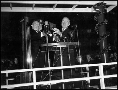 President Harry Truman pushes the button to turn on the lights for the 1945 National Community Christmas Tree. 