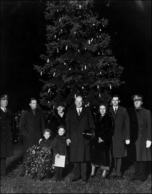 President Herbert Hoover and his family posed in front of the 1931 National Community Christmas Tree. Like many First Ladies, Lou Hoover was active in community service throughout her life. When her husband served in the Cabinet, Mrs. Hoover played the role of Mrs. Santa Claus at a Washington, D.C. Children's Hospital.