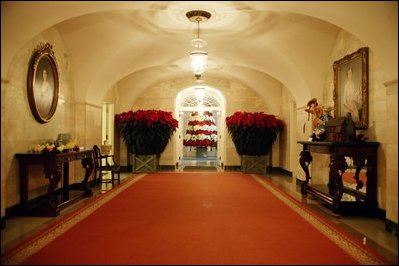 Decorated with storybook characters and poinsettias, the Ground Floor of the White House residence is ready for the 2003 Christmas season.
